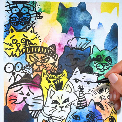 Colorful drawing worksheet of funny grumpy cats and funny kittens with a hand holding a marker.