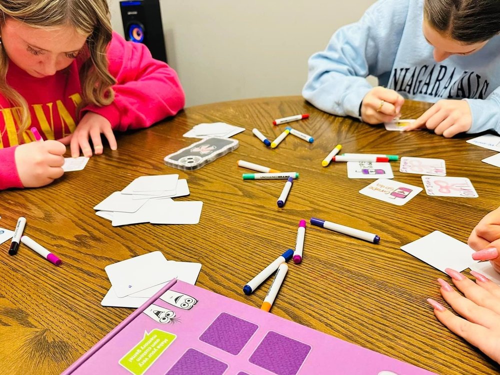 Kids and adults drawing together at a table, screen-free family activity for all ages