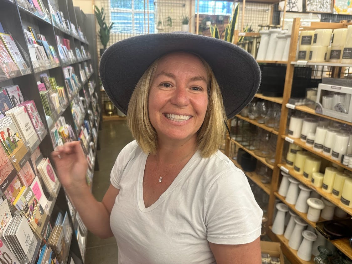 Janet, founder of UnchainedBrainz, smiling in a bookstore